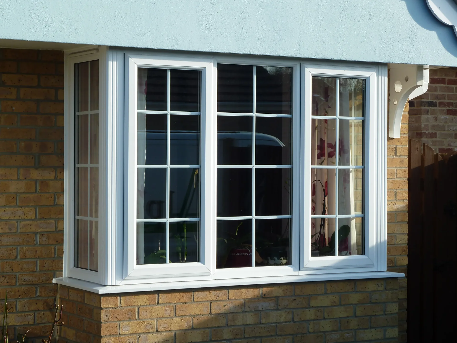 White bay window on a brick exterior