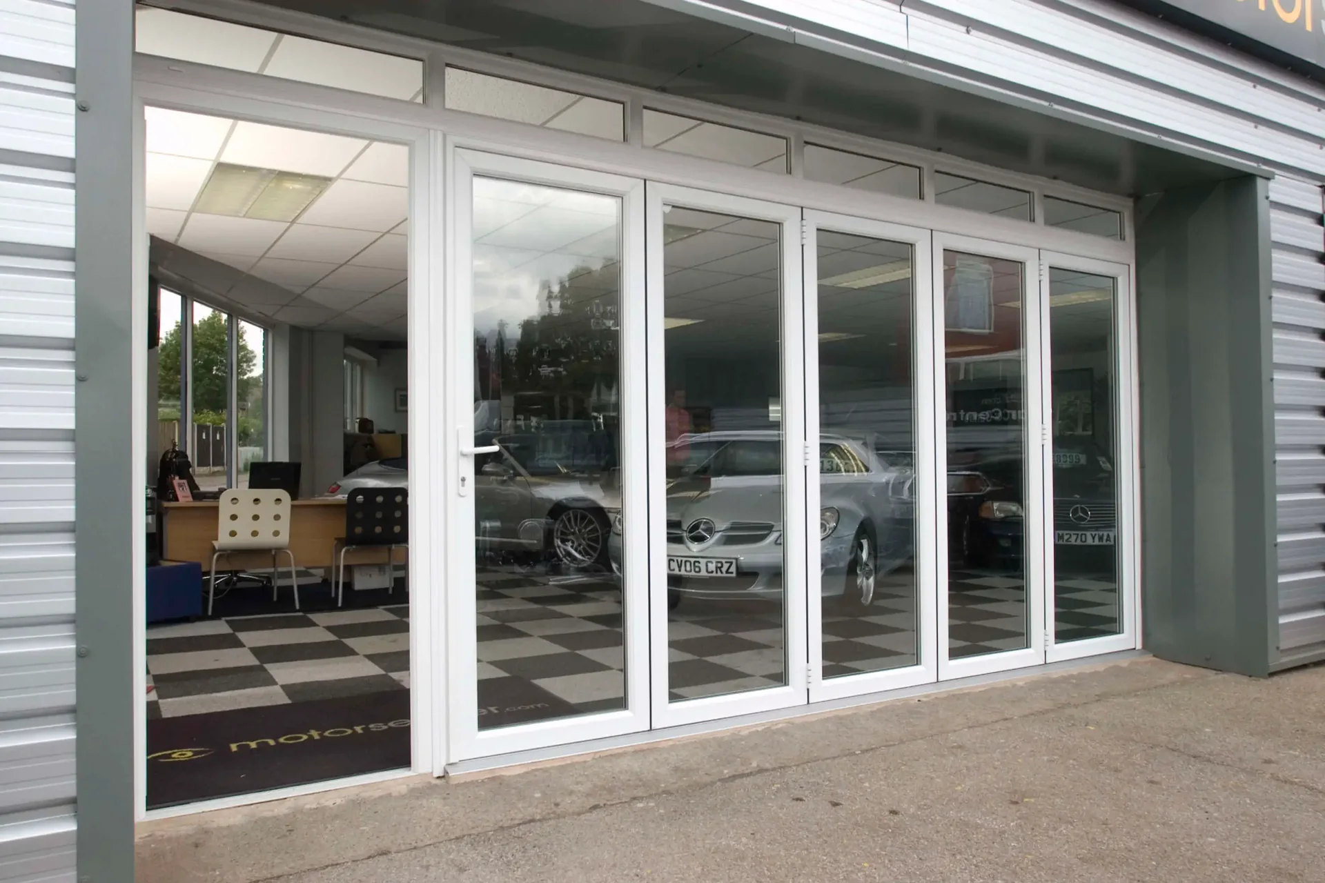 Wide white bifolding doors open to a patio