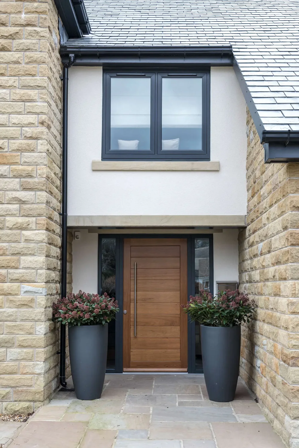 Contemporary entrance with a warm timber-effect front door